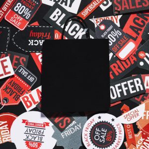 black-paper-bag-lying-many-colorful-labels-with-sale-offer